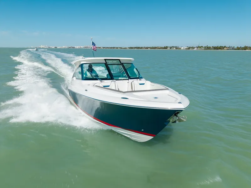 Slide: The Image of 2023 Tiara Yachts 34 LX cruising on open water, sunny day. - 16