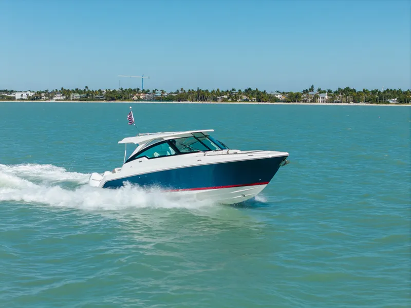 Slide: The Image of 2023 Tiara Yachts 34 LX cruising on water, sunny day. - 18