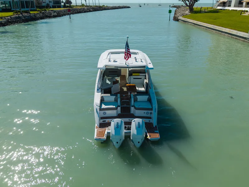 Slide: The Image of 2023 Tiara Yachts 34 LX on calm water with flag. - 2