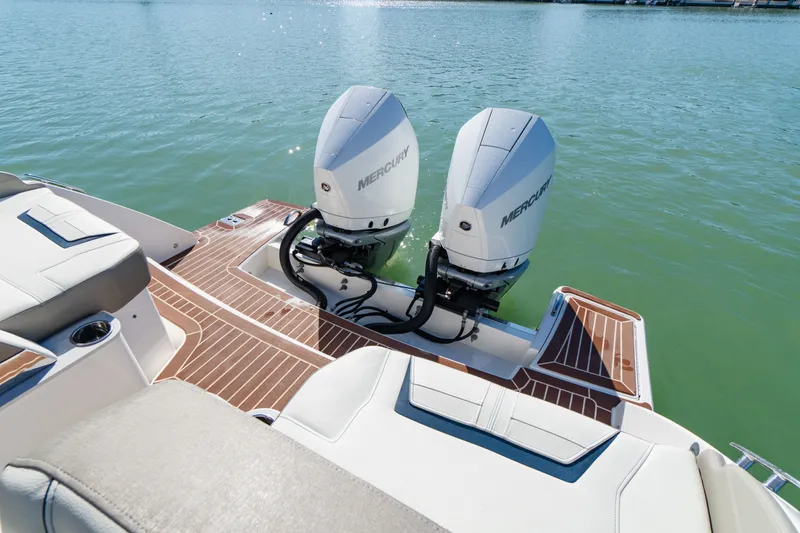 Slide: The Image of 2023 Tiara Yachts 34 LX with twin Mercury engines on calm water. - 21