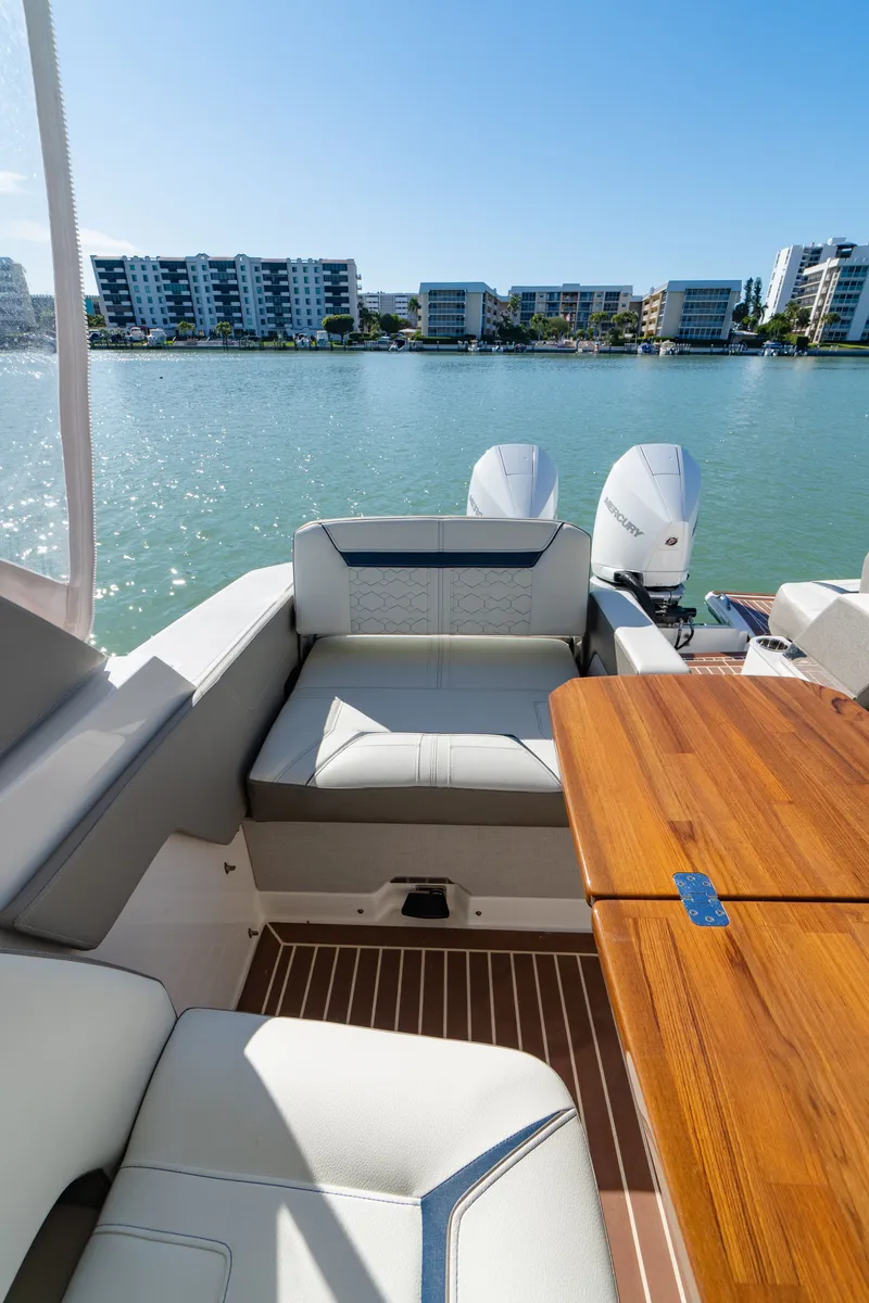 Slide: The Image of Interior of 2023 Tiara Yachts 34 LX with wooden table and seating area. - 26