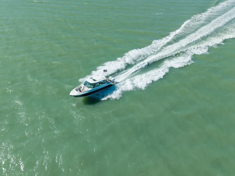 Slide: The Image of Tiara Yachts 34 LX 2023 cruising on open sea, aerial view. - 3