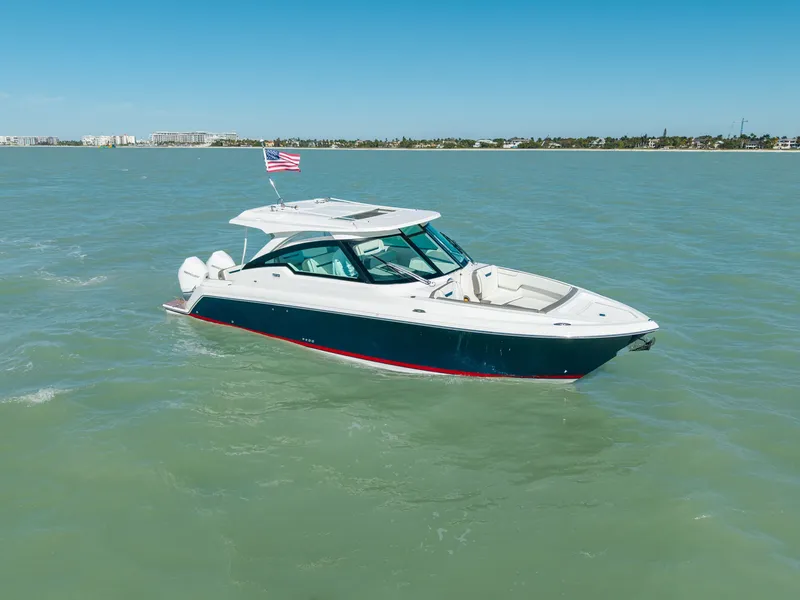 Slide: The Image of 2023 Tiara Yachts 34 LX on calm waters with American flag. - 4