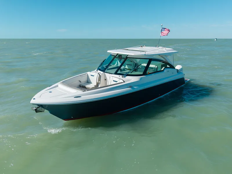 Slide: The Image of 2023 Tiara Yachts 34 LX on calm sea with American flag. - 5