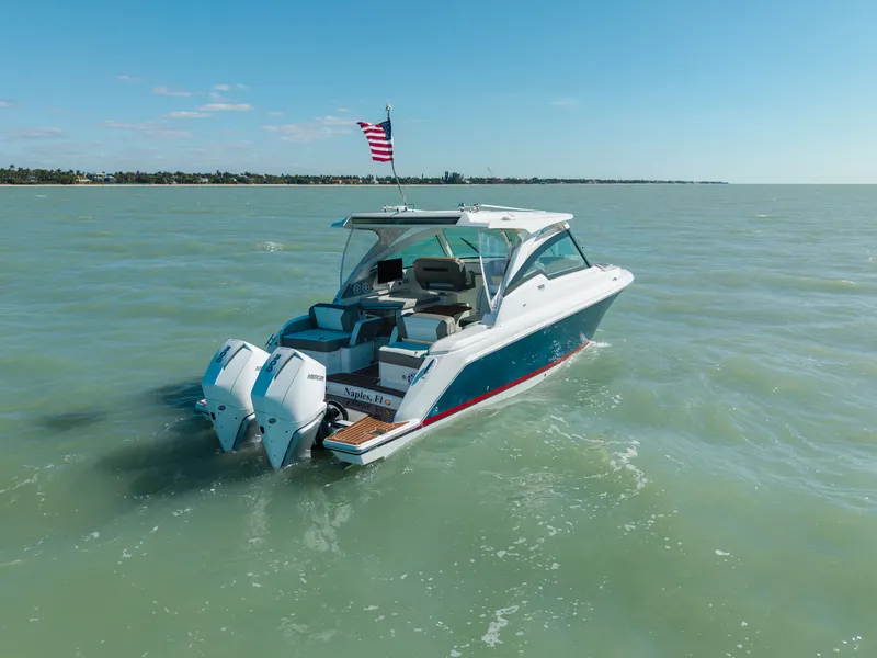 Slide: The Image of 2023 Tiara Yachts 34 LX on open water with American flag. - 6