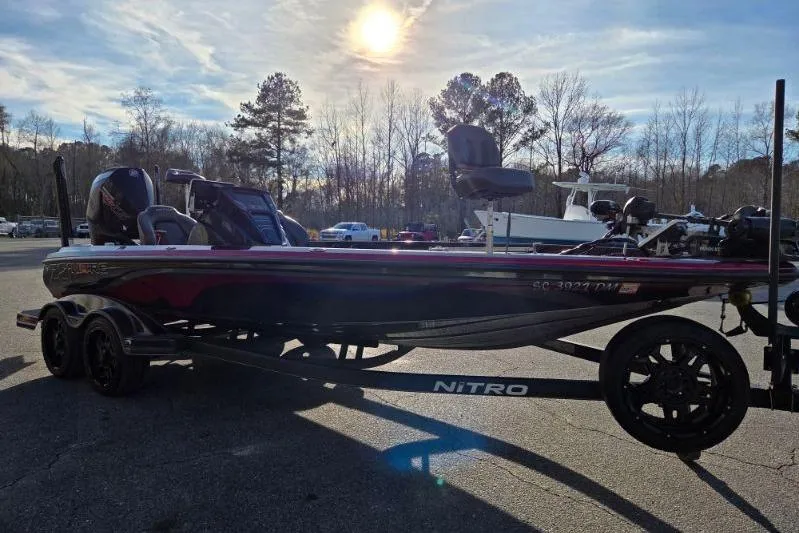 Slide: The Image of 2020 Nitro Z21 boat on trailer under sunny sky in parking lot. - 6