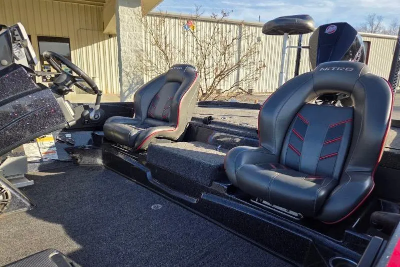 Slide: The Image of 2020 Nitro Z21 boat interior with black and red seats, steering wheel, and console. - 9