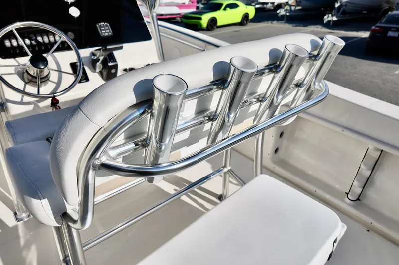 Slide: The Image of 2026 Bulls Bay 230 Center Console boat interior with rod holders and steering wheel. - 10