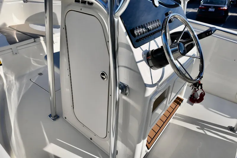 Slide: The Image of 2026 Bulls Bay 230 Center Console boat interior with steering wheel and control panel. - 12