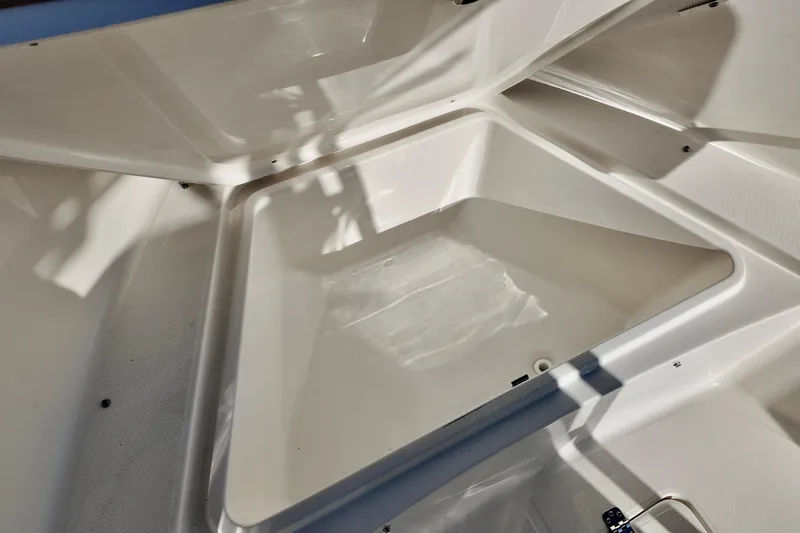 Slide: The Image of 2026 Bulls Bay 230 Center Console boat storage compartment, open and empty. - 17
