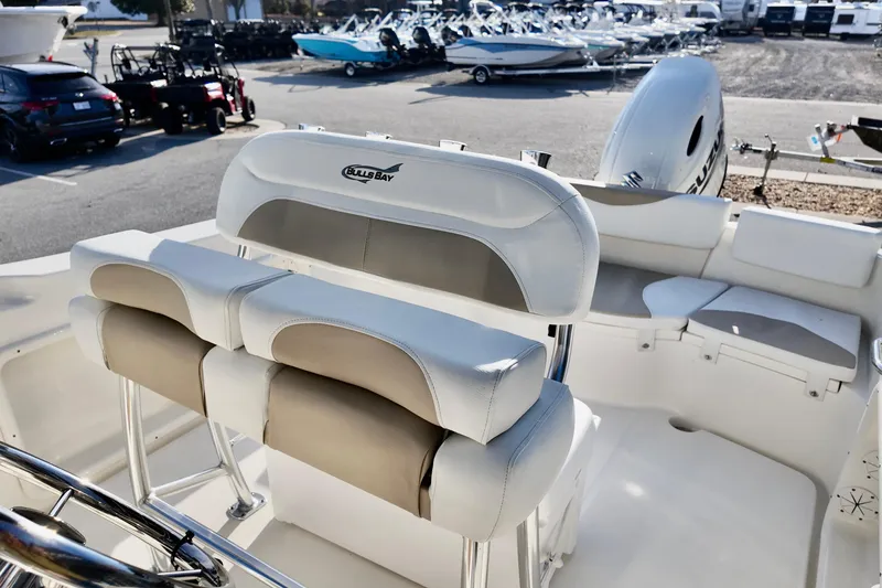 Slide: The Image of 2026 Bulls Bay 230 Center Console boat interior with seating and steering wheel. - 4