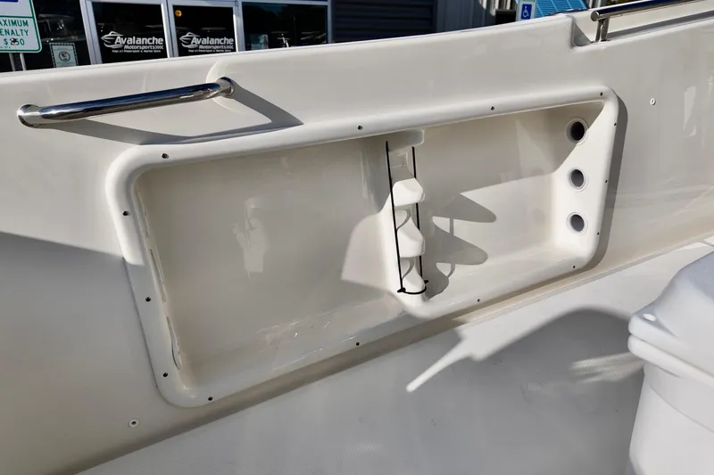Slide: The Image of 2026 Bulls Bay 230 Center Console boat interior detail with storage compartment. - 6