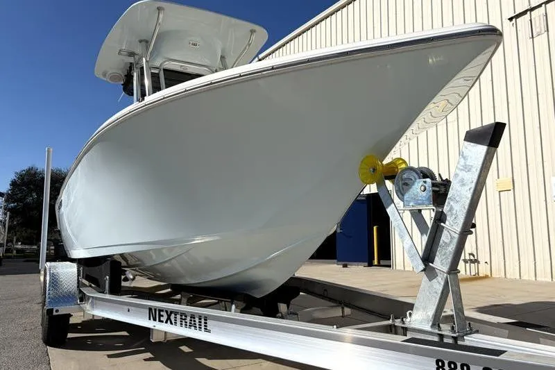 Slide: The Image of 2024 Key West 203 FS boat on Nextrail trailer, parked outside a building. - 10