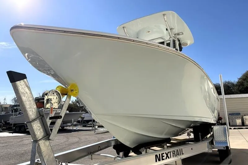 Slide: The Image of 2024 Key West 203 FS boat on trailer under clear blue sky. - 11