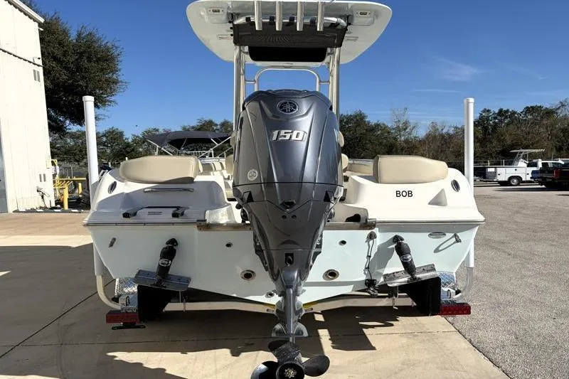 Slide: The Image of 2024 Key West 203 FS boat with Yamaha 150 outboard motor, parked outdoors. - 12