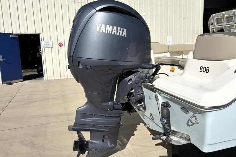Slide: The Image of 2024 Key West 203 FS boat with Yamaha outboard motor in a marina setting. - 15
