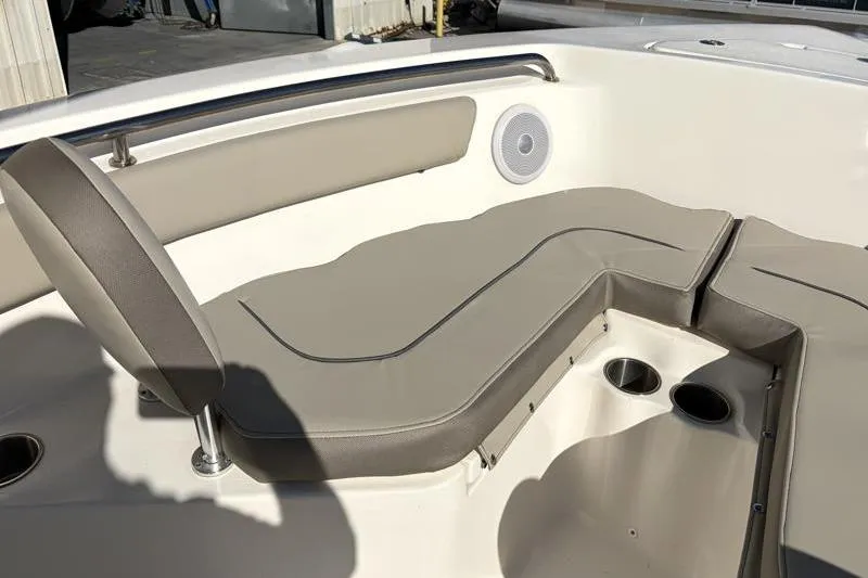 Slide: The Image of 2024 Key West 203 FS boat interior with cushioned seating and cup holders. - 20
