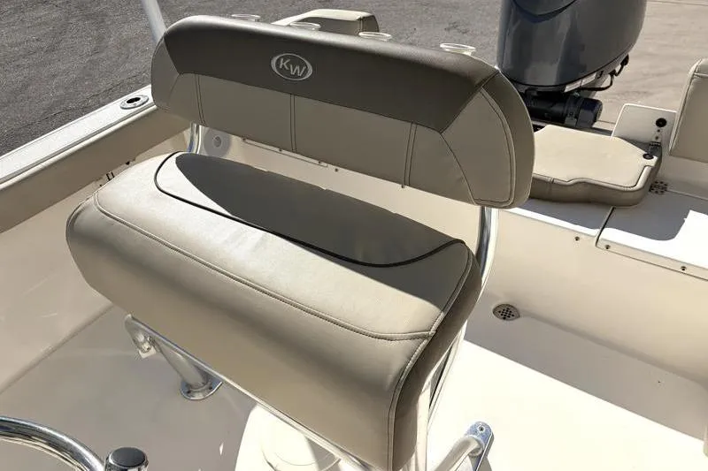 Slide: The Image of 2024 Key West 203 FS boat seat with beige upholstery and KW logo. - 25