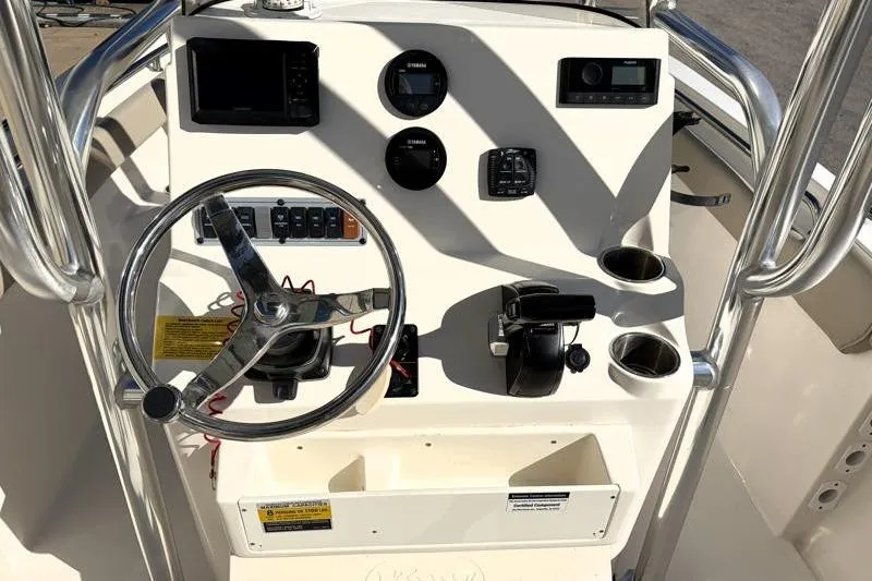 Slide: The Image of 2024 Key West 203 FS boat console with steering wheel and controls. - 26