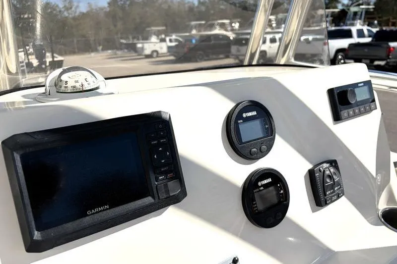 Slide: The Image of 2024 Key West 203 FS boat dashboard with Garmin and Yamaha instruments. - 27