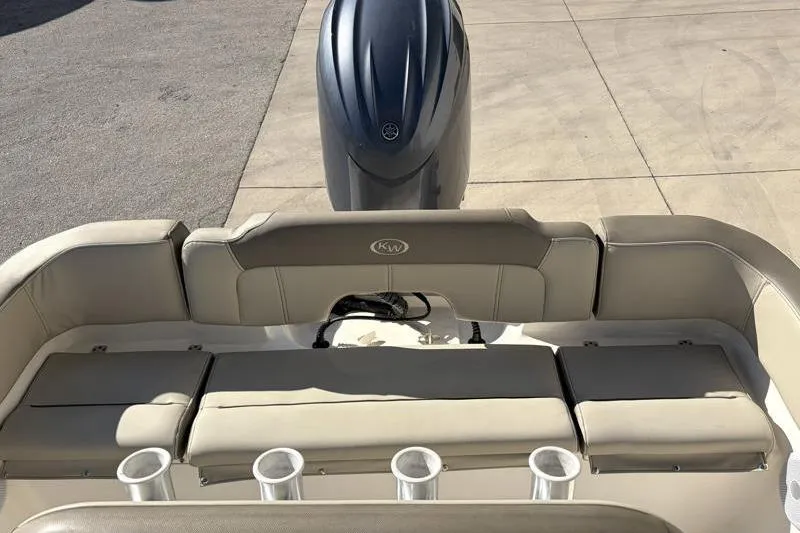 Slide: The Image of 2024 Key West 203 FS boat interior with cushioned seating and motor. - 31