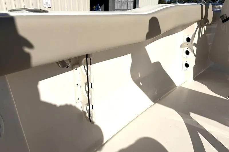 Slide: The Image of 2024 Key West 203 FS boat interior detail with beige seating and rod holders. - 35