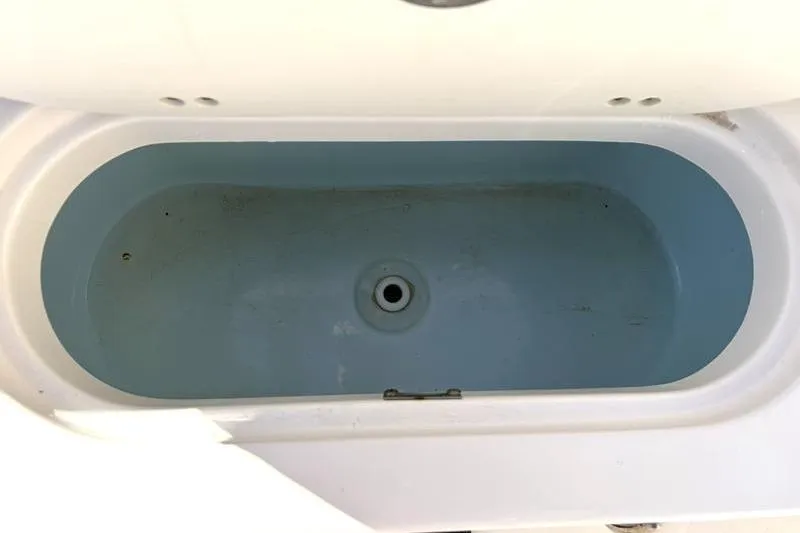 Slide: The Image of Livewell compartment in 2024 Key West 203 FS boat, featuring a clean, white interior. - 36