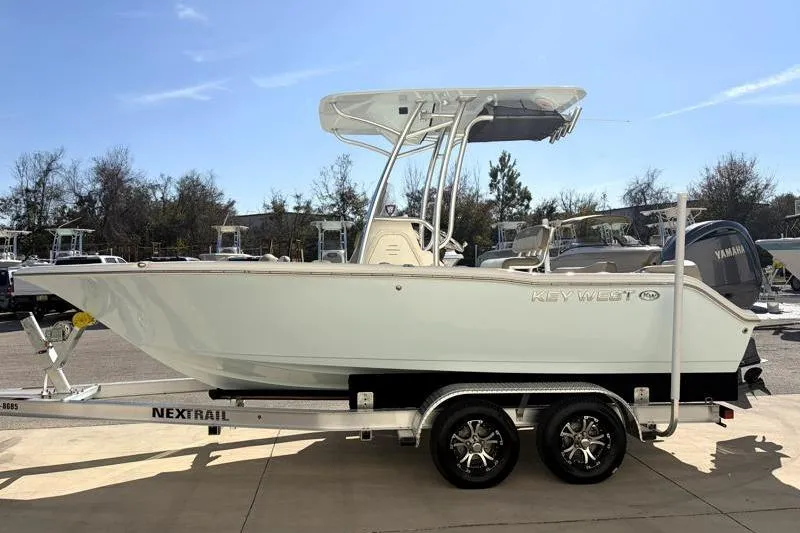 Slide: The Image of 2024 Key West 203 FS boat on Nextrail trailer, parked outdoors. - 5