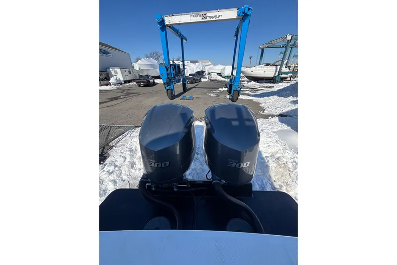 Slide: The Image of 2011 Regulator 28 Forward Seating boat with twin 300 horsepower engines in snowy marina. - 13