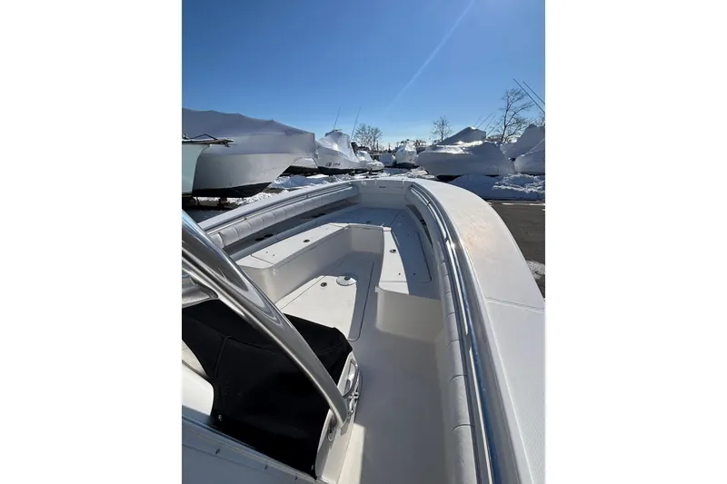 Slide: The Image of 2011 Regulator 28 Forward Seating boat under clear blue sky, parked with snow-covered surroundings. - 20