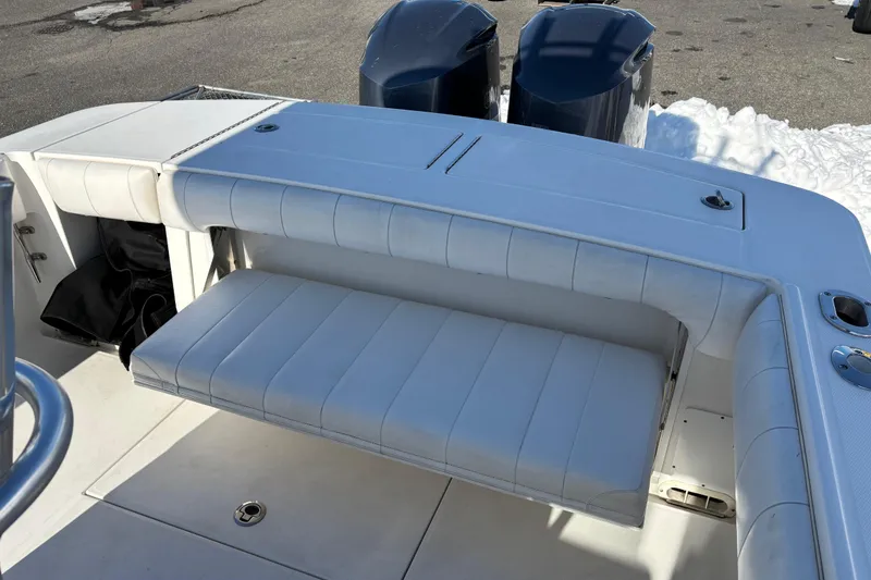Slide: The Image of 2011 Regulator 28 Forward Seating boat with white cushioned seats and dual engines. - 25