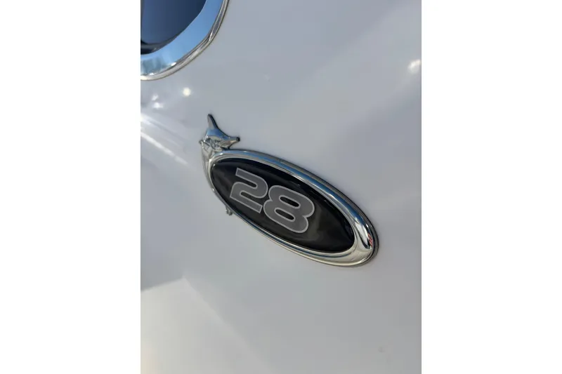 Slide: The Image of 2011 Regulator 28 Forward Seating boat emblem on white surface. - 26