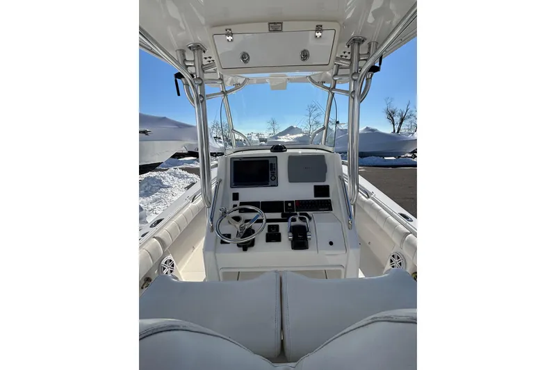 Slide: The Image of 2011 Regulator 28 Forward Seating boat interior with helm, steering wheel, and controls. - 31