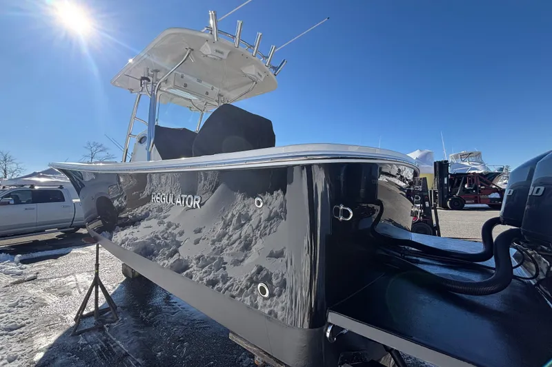 Slide: The Image of 2011 Regulator 28 Forward Seating boat under bright blue sky. - 8