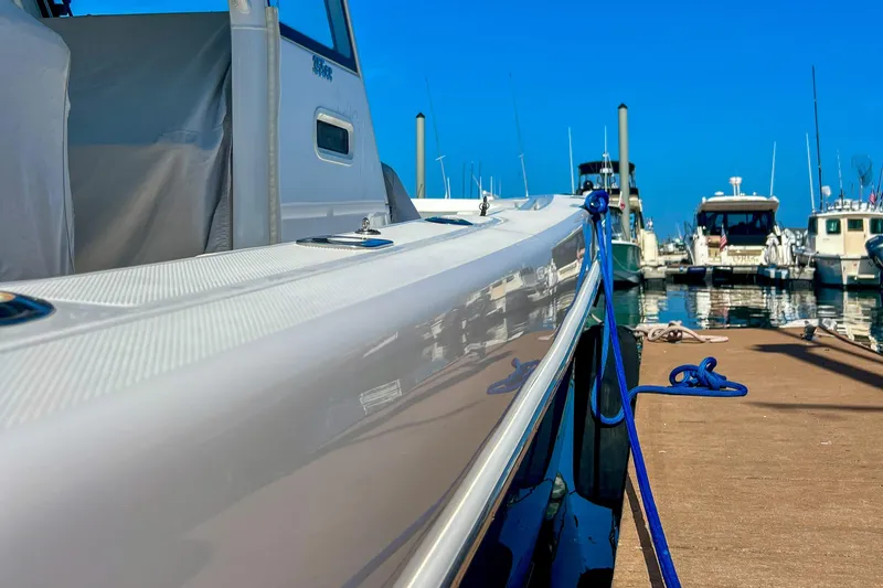 Slide: The Image of 2017 Everglades 355 Center Console docked at marina, blue sky background. - 14