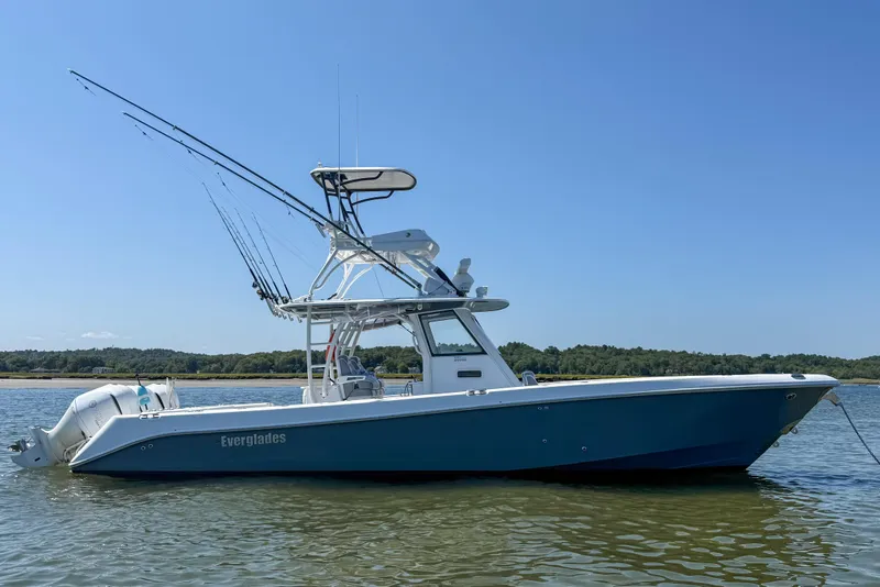 Slide: The Image of 2017 Everglades 355 Center Console boat on calm water, clear sky background. - 15
