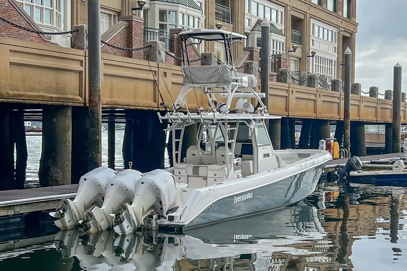 Slide: The Image of 2017 Everglades 355 Center Console boat docked at marina with triple outboard engines. - 4