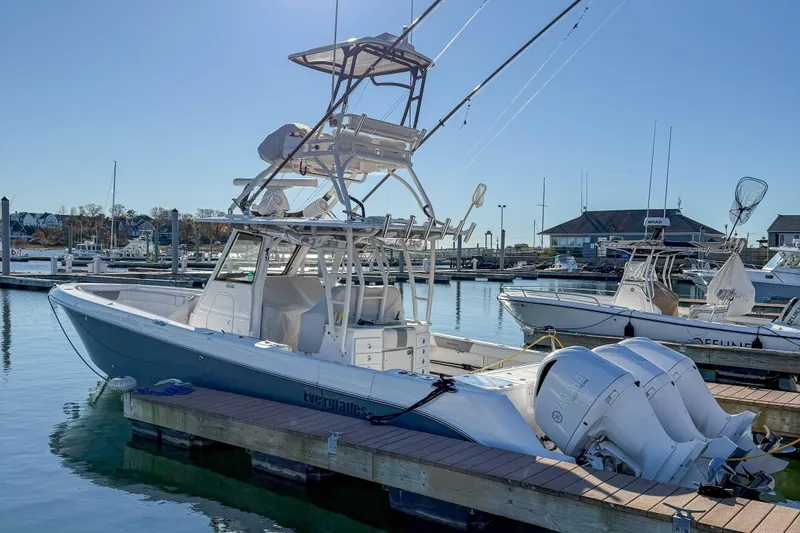Slide: The Image of 2017 Everglades 355 Center Console boat docked at marina with clear blue sky. - 6