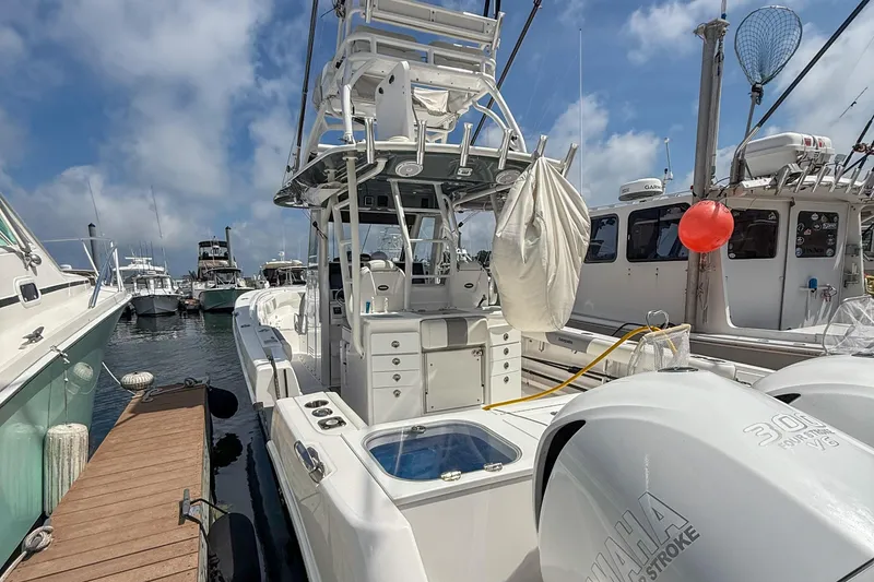 Slide: The Image of 2017 Everglades 355 Center Console boat docked with Yamaha engines, clear sky background. - 7