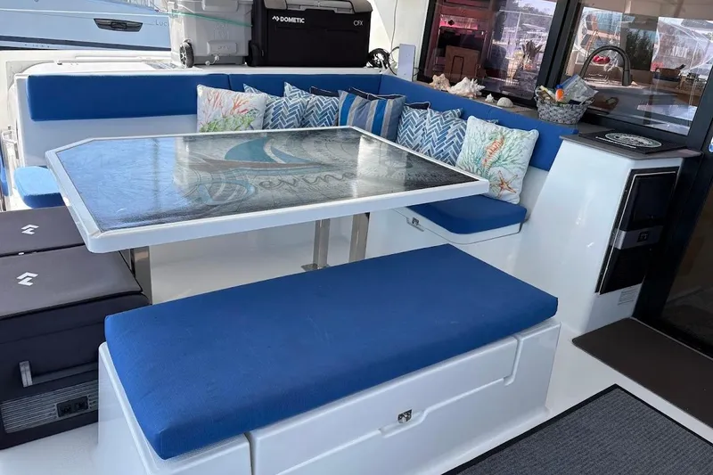 Slide: The Image of Luxurious 2015 Fountaine Pajot SABA 50 yacht interior with blue seating and decorative pillows. - 14