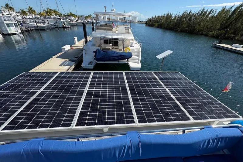 Slide: The Image of 2015 Fountaine Pajot SABA 50 yacht with solar panels docked at marina. - 21