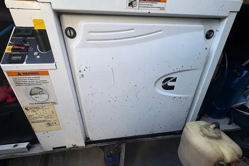 Slide: The Image of Cummins generator on 2015 Fountaine Pajot SABA 50 yacht, with control panel and warning labels. - 22