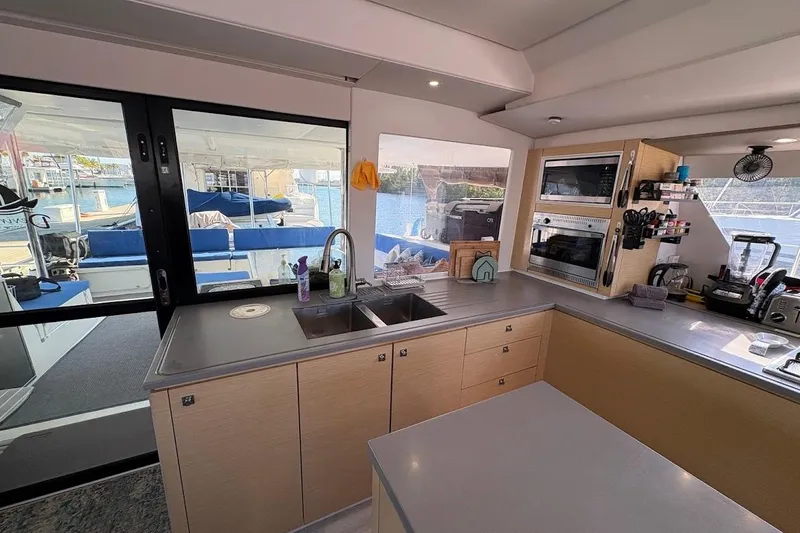 Slide: The Image of Modern kitchen interior of 2015 Fountaine Pajot SABA 50 catamaran with sleek countertops and appliances. - 3