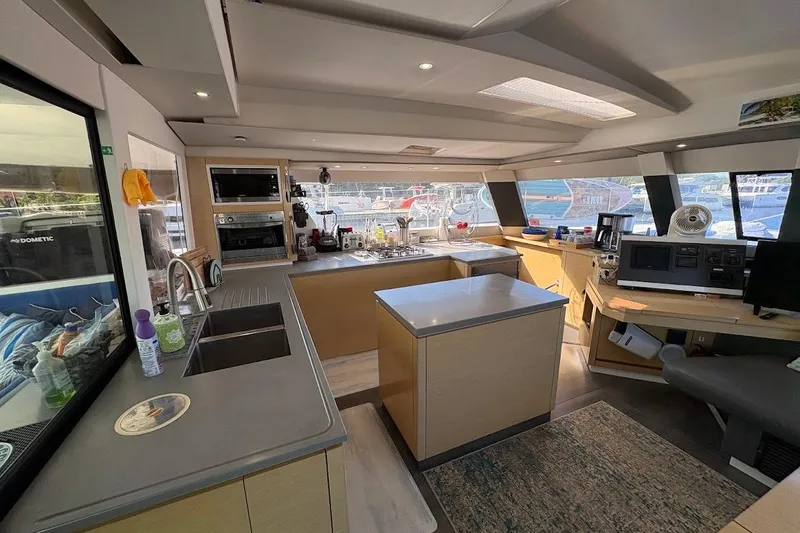 Slide: The Image of Luxurious interior of 2015 Fountaine Pajot SABA 50 catamaran with modern kitchen and navigation area. - 5