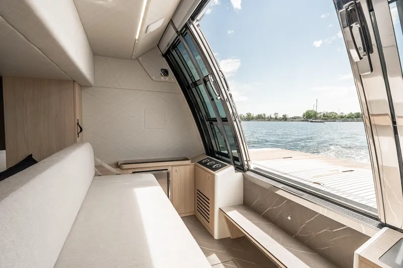 Slide: The Image of Luxurious interior of 2022 Absolute 64 Navetta yacht with panoramic water view. - 56