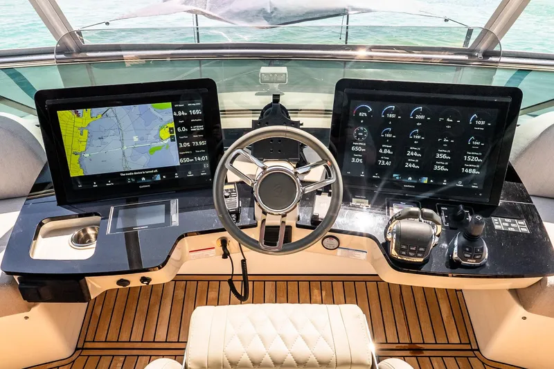 Slide: The Image of Cockpit of 2022 Absolute 64 Navetta yacht with advanced navigation displays and controls. - 48