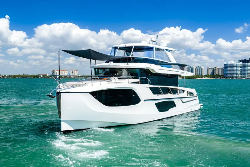 Slide: The Image of Luxurious 2022 Absolute 64 Navetta yacht cruising on clear blue waters. - 16