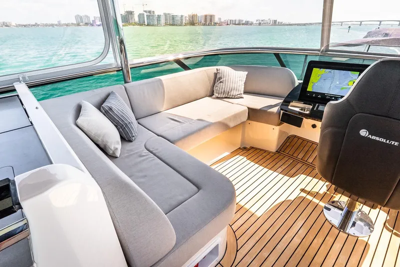 Slide: The Image of Luxurious interior of 2022 Absolute 64 Navetta yacht with plush seating and navigation display. - 50