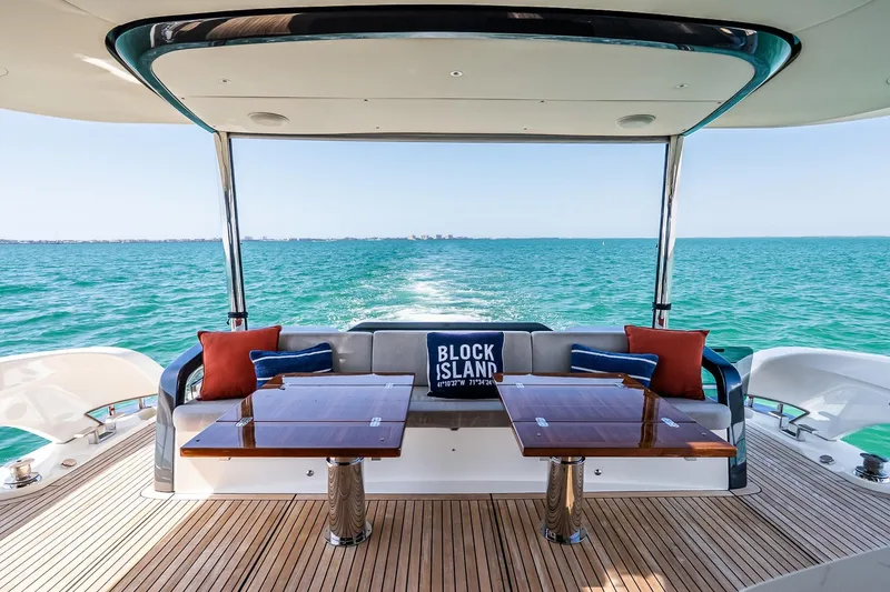 Slide: The Image of Luxurious 2022 Absolute 64 Navetta yacht deck with ocean view and elegant seating. - 60