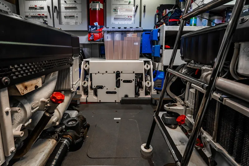 Slide: The Image of Engine room of 2022 Absolute 64 Navetta yacht, featuring machinery and storage. - 111
